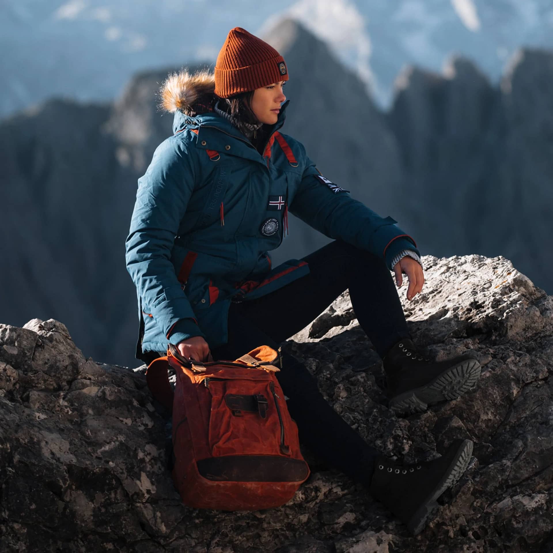 woman in Teal Polar Jacket sat on rock