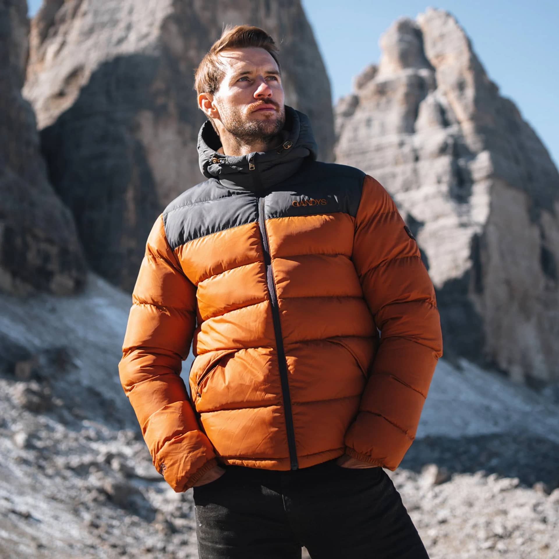 man in a burnt-orange-explorer-hooded-puffer-jacket-